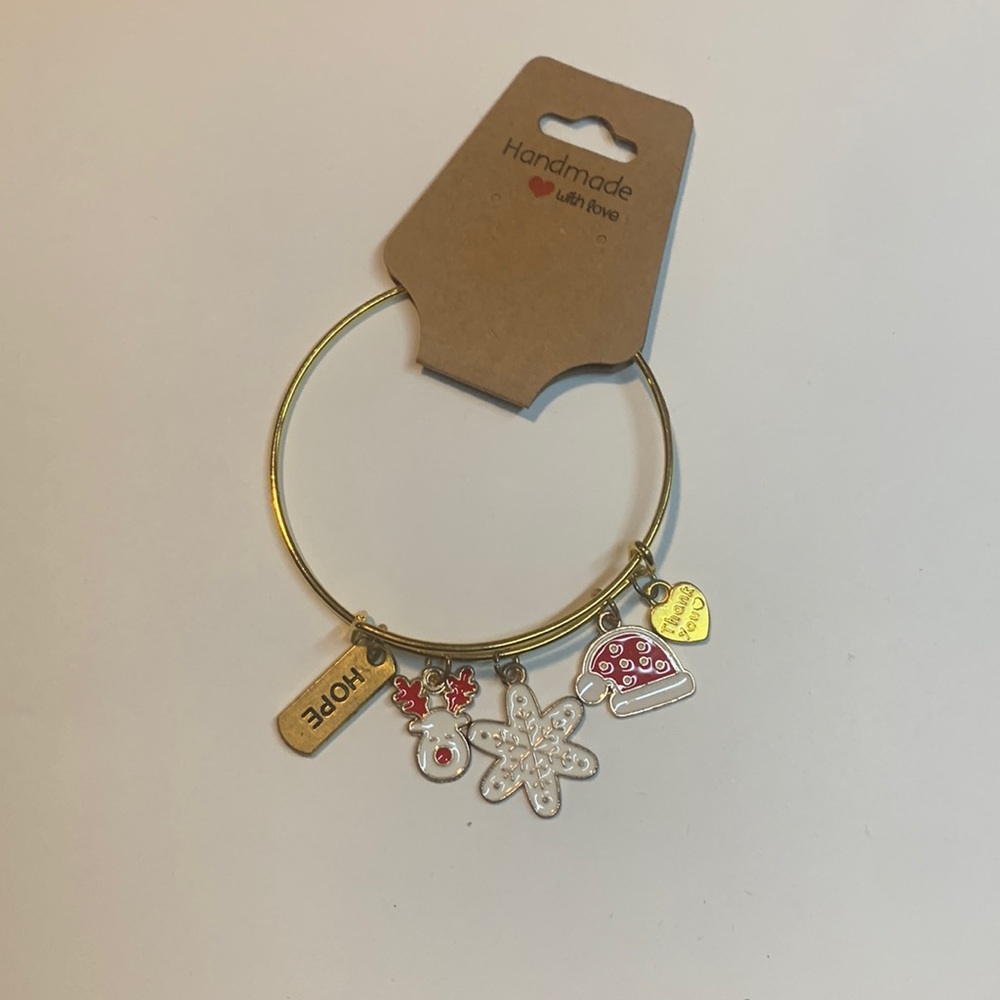 Handmade gold tone stainless steel bracelet with 5 charms.